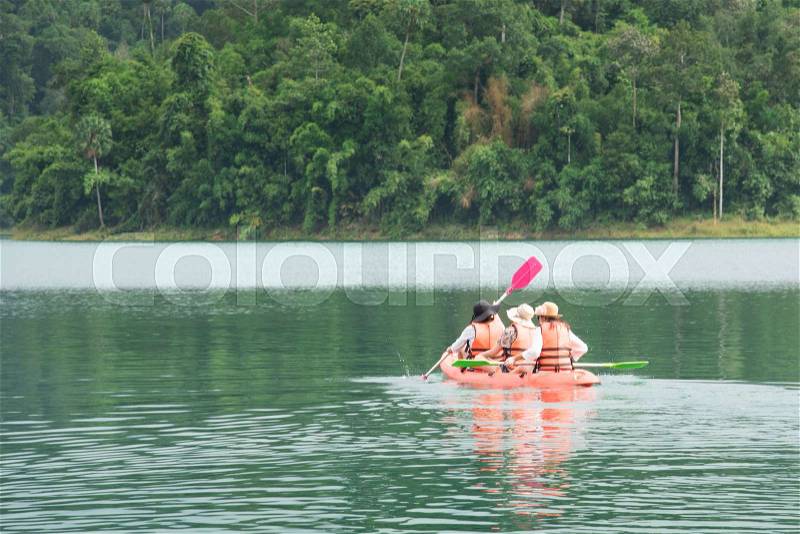 Traveler kayaking in river of Thailand, stock photo