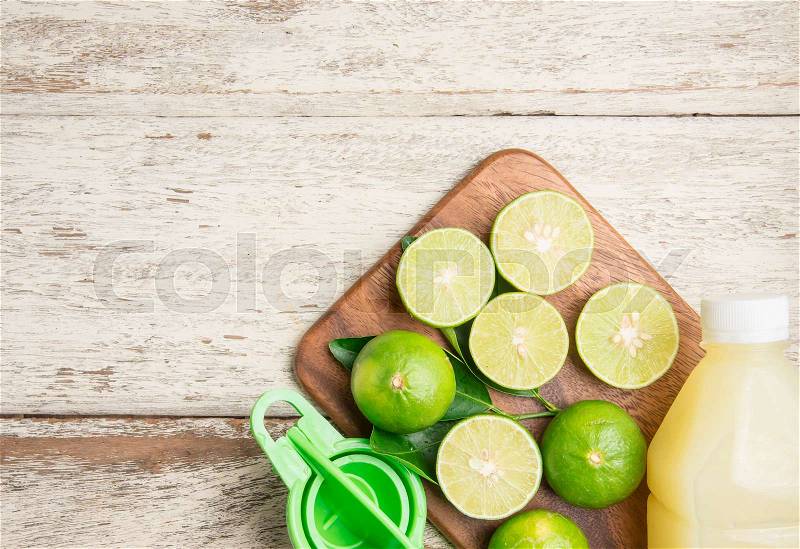 Freshly squeezed lime juice with lime fruits on wood table,top view, stock photo