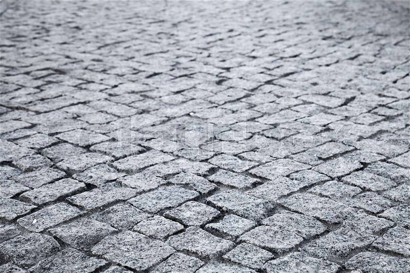 Dark gray cobble road, granite stone street pavement, background photo with selective focus, stock photo