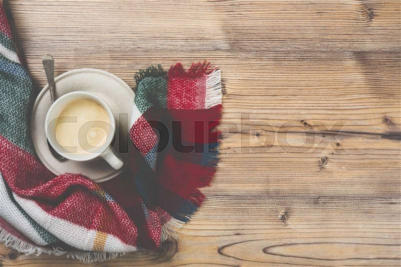 Cozy home coffee cup with plaid, warm details background, vintage filter, stock photo