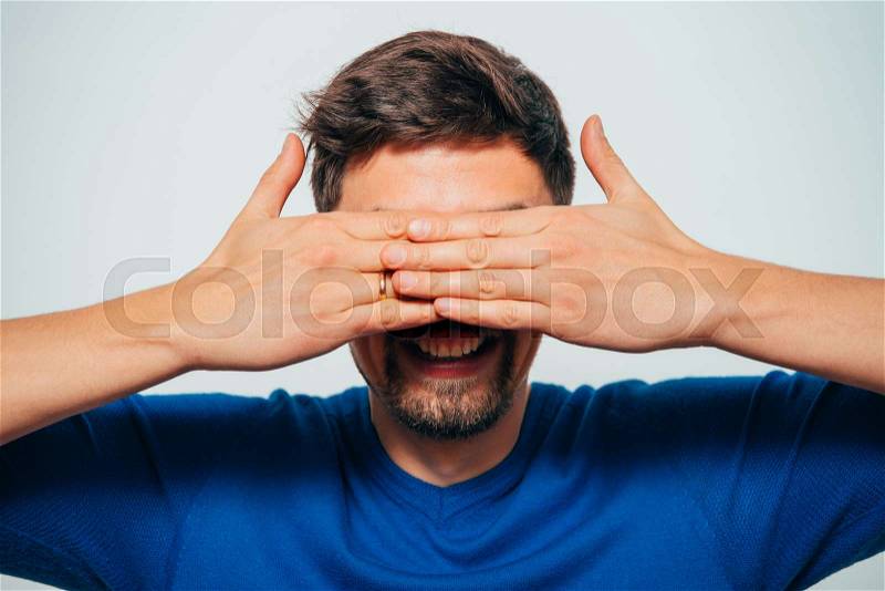 Man closes eyes with her hands, stock photo