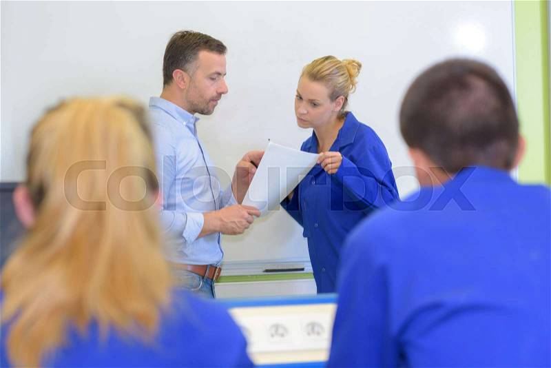 College students in classroom with teacher, stock photo