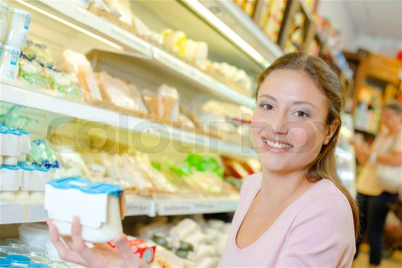Woman buying yoghurt, stock photo