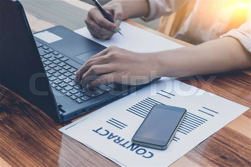 Business technology concept,Business people hands use smart phone and laptop for business analyst project on table ,selective focus, stock photo