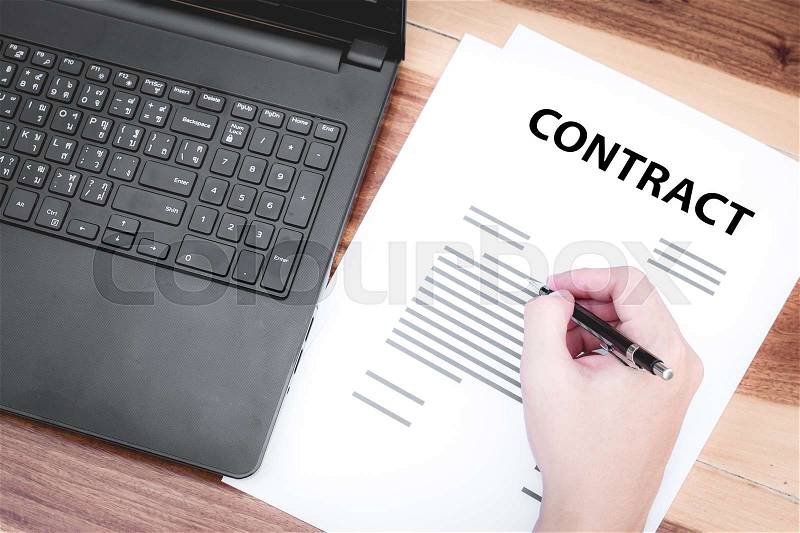 Business insurance lawyer concept : hand using pen sign business contracts agreement paper ,selective focus, stock photo