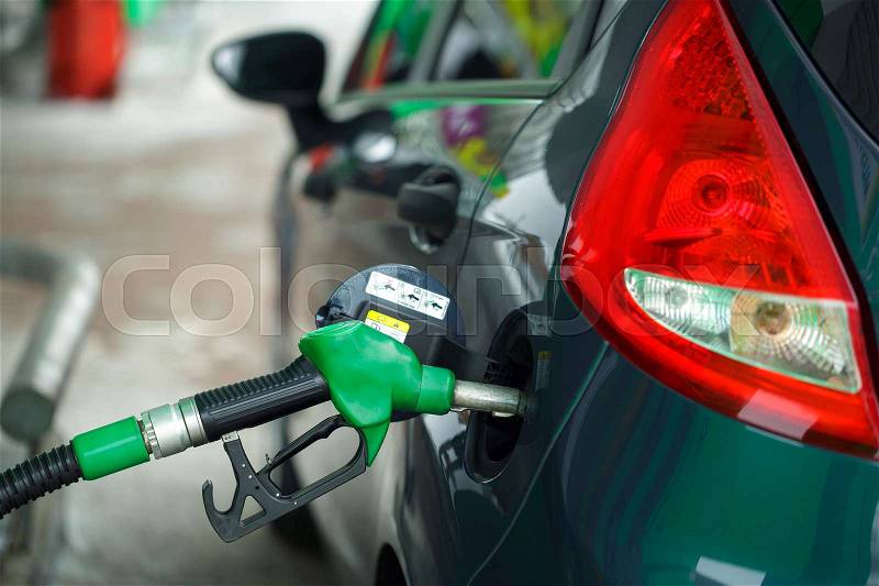 Car refueling on a petrol station in winter close up, stock photo