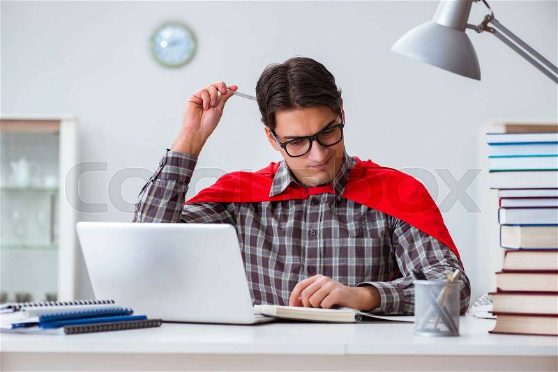 Super hero student with books studying for exams, stock photo