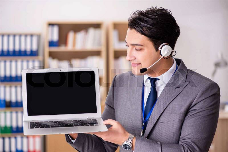 Handsome customer service clerk with headset , stock photo