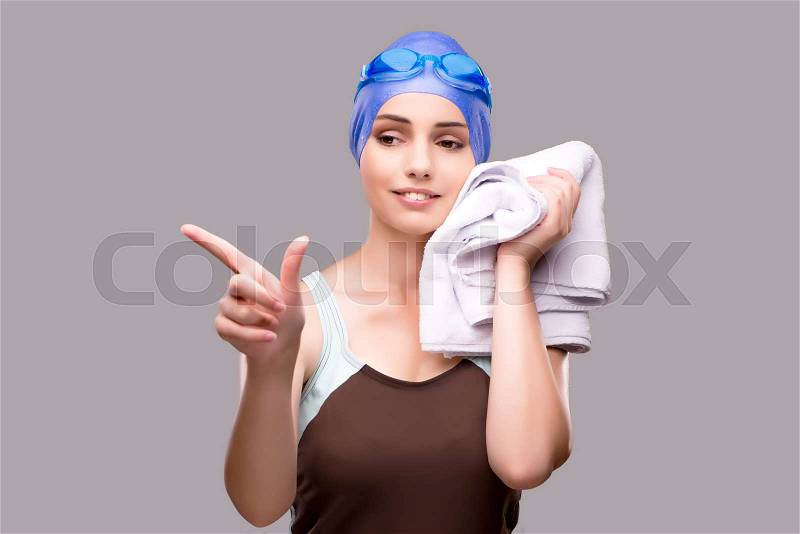Woman swimmer against grey background, stock photo