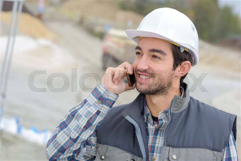 Engineer having a mobile conversation, stock photo