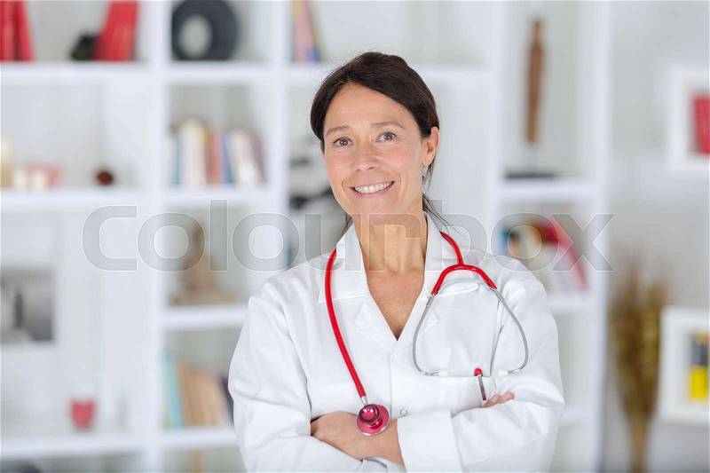 Doctor standing arms crossed, stock photo