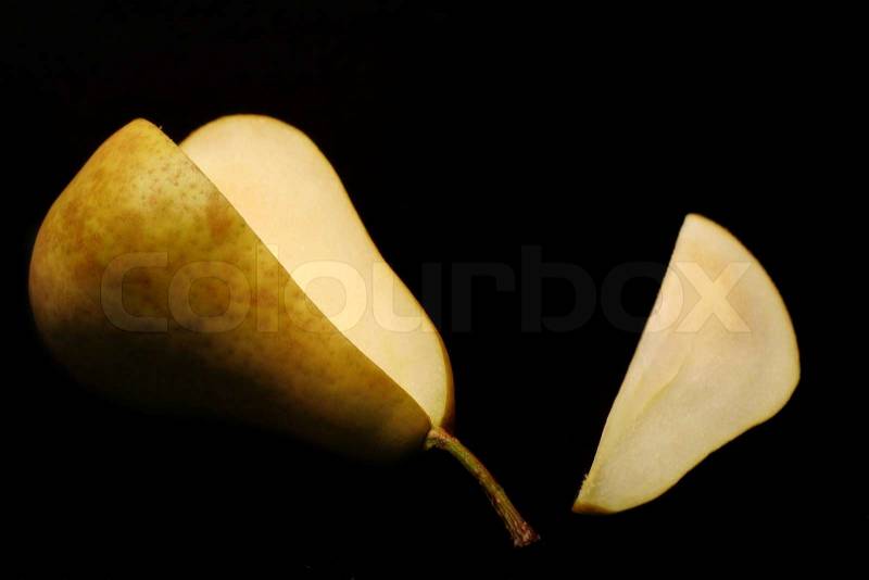 Pear with sliced removed on black background, stock photo