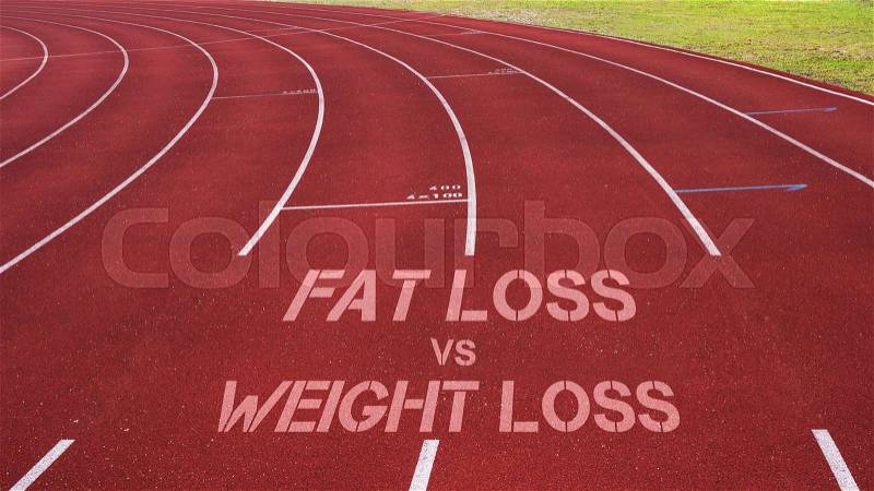 Motivational quote written on running track: Fat Loss vs Weight Loss, stock photo