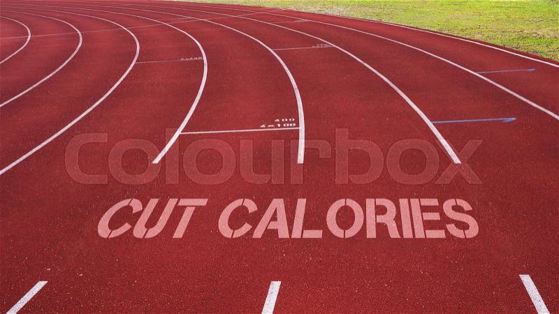 Motivational quote written on running track: Cut Calories, stock photo