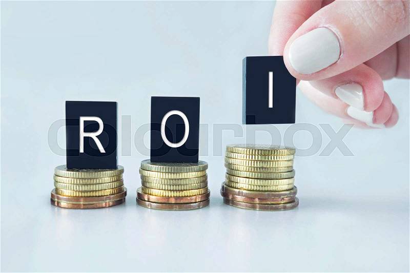 ROI text stacked on coins with cool image temperature , stock photo