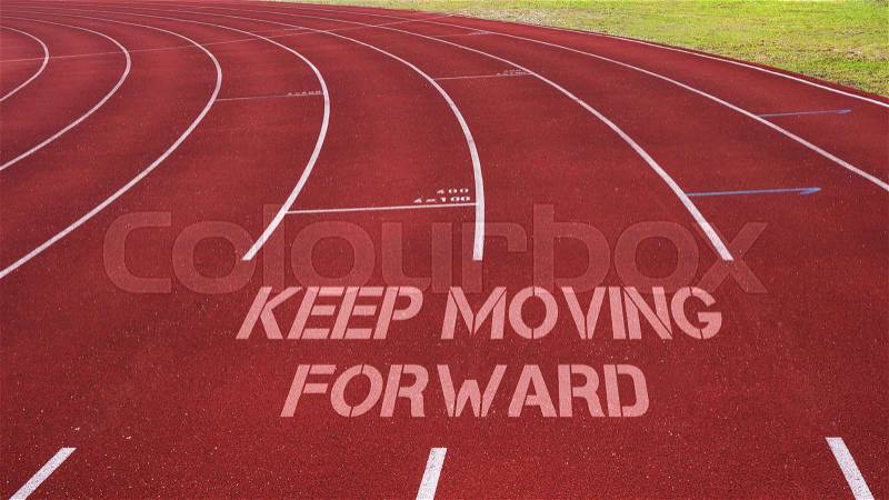 Motivational quote written on running track: Keep Moving Forward, stock photo