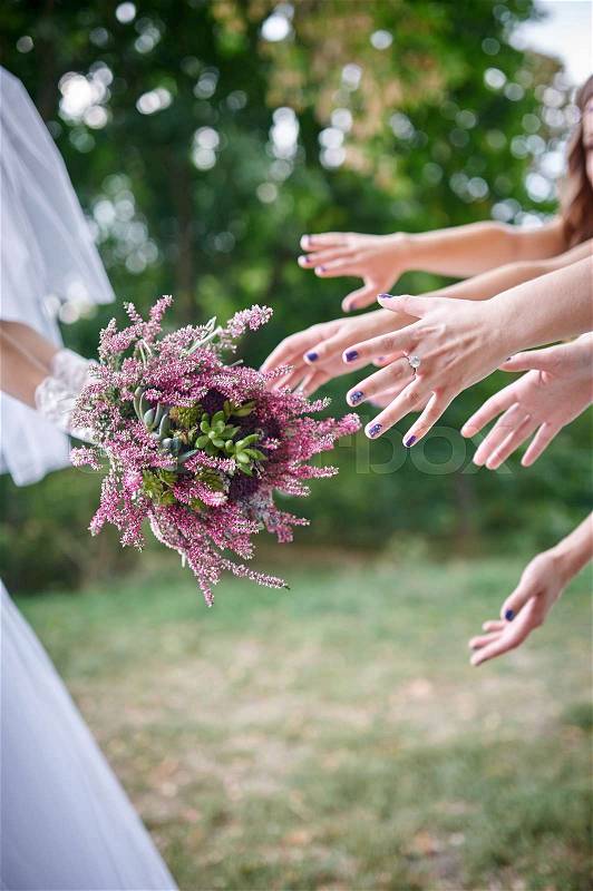 Bride Throwing Bouquet For Guests To Catch, stock photo
