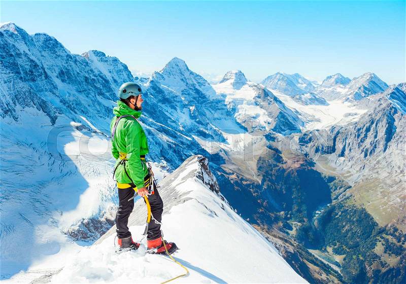 Young man on the top of a mountain. Extreme sport concept, stock photo