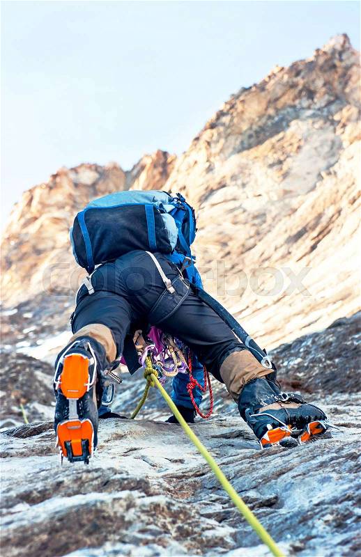 A young climbers reaching the summit. Extreme sport concept, stock photo