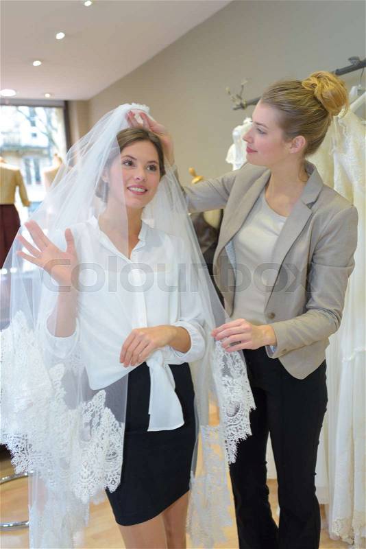 Lady trying on wedding veil, stock photo