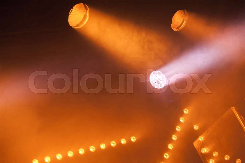 Spot lights with yellow rays in smoke, stage illumination equipment, stock photo