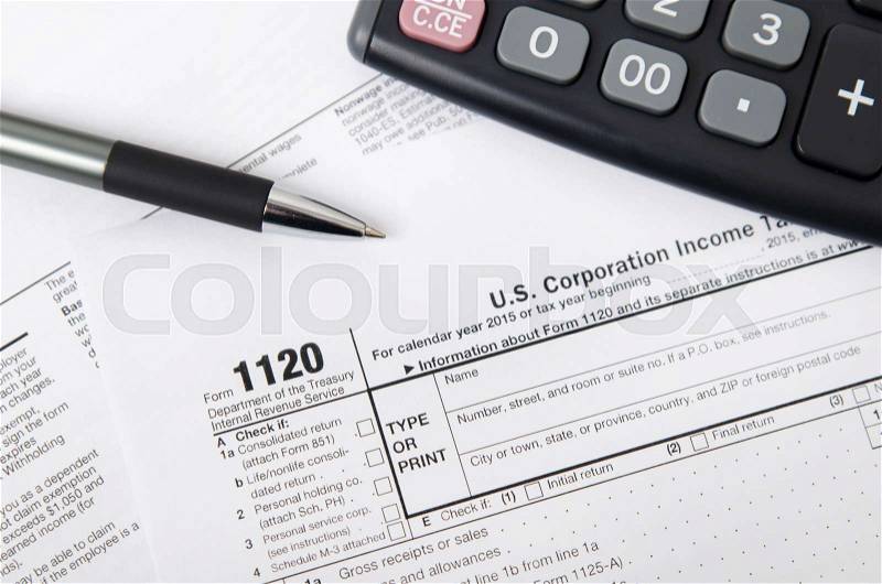 US tax form 1120 with pen and calculator. tax form law document usa white mathematics business concept, stock photo