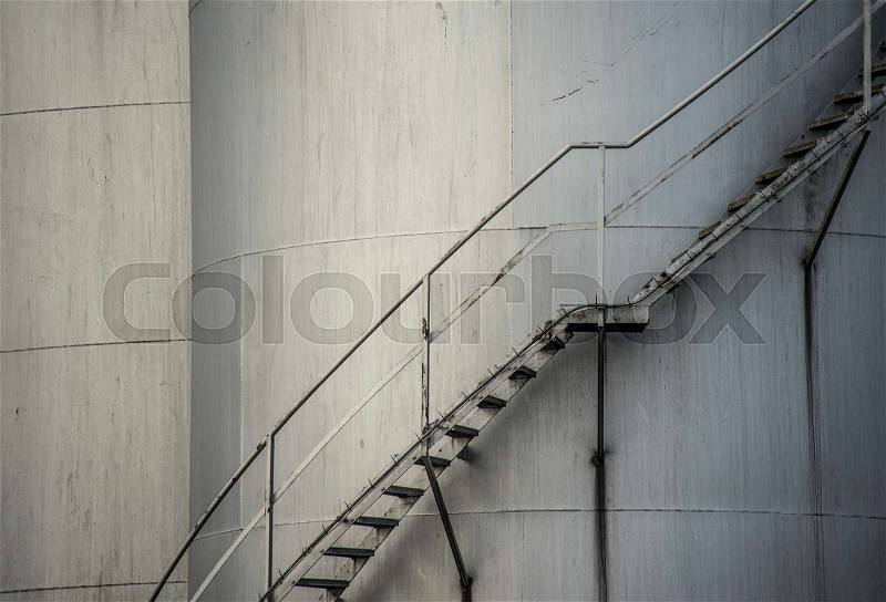 Industrial silos with external staircase, close up, stock photo