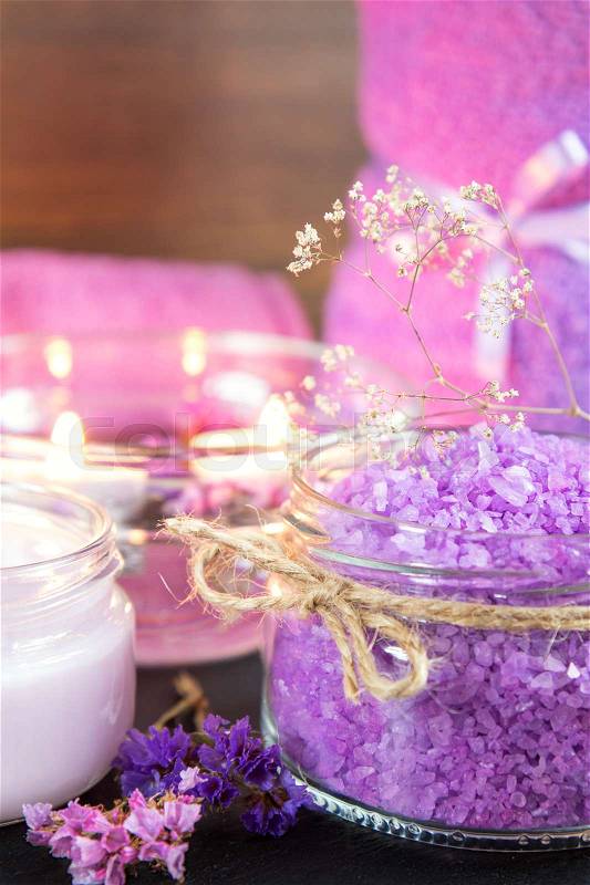 Spa products. Lavender bath salts, dry flowers, cosmetic cream, light candles and towel. Violet purple concept. Coloring and processing photo, stock photo