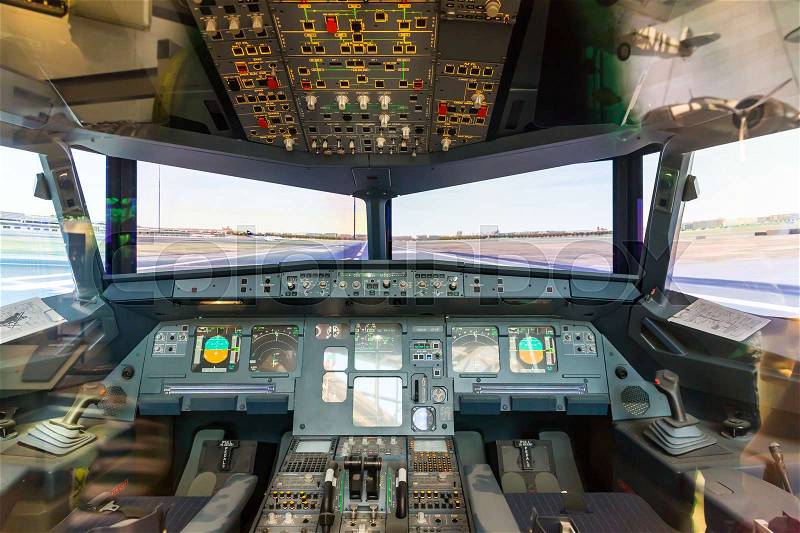 Inside airplane pilot cabin. Avionics dashboard, steering wheels, windows, stock photo