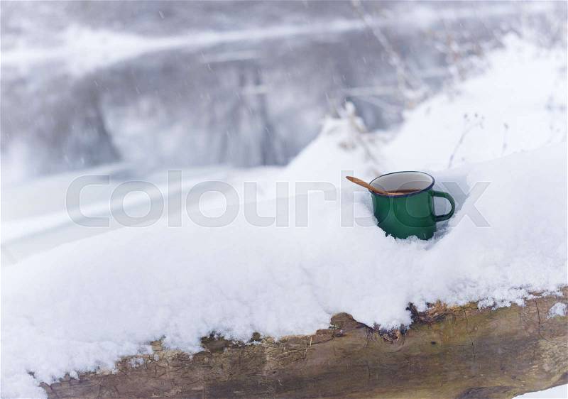 Tea mug in the snow.cold winter and hot tea, stock photo