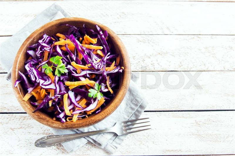 Red Cabbage Coleslaw Salad with Carrots and Greens - healthy diet, detox, vegan, vegetarian, vegetable spring salad, copy space for text, stock photo