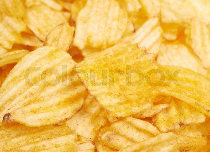 Surface covered with multiple seasoned potato chips crisps as a background composition, stock photo