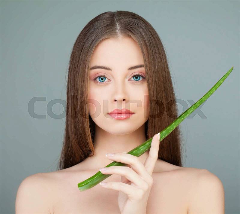 Healthy Model Girl Holding Green Aloe Leaf. Skin Care Concept, stock photo