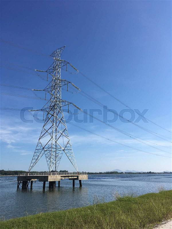 High voltage electric post of electricity transfer from power plant near sea shore to city , Winter season , Eastern of Thailand, stock photo