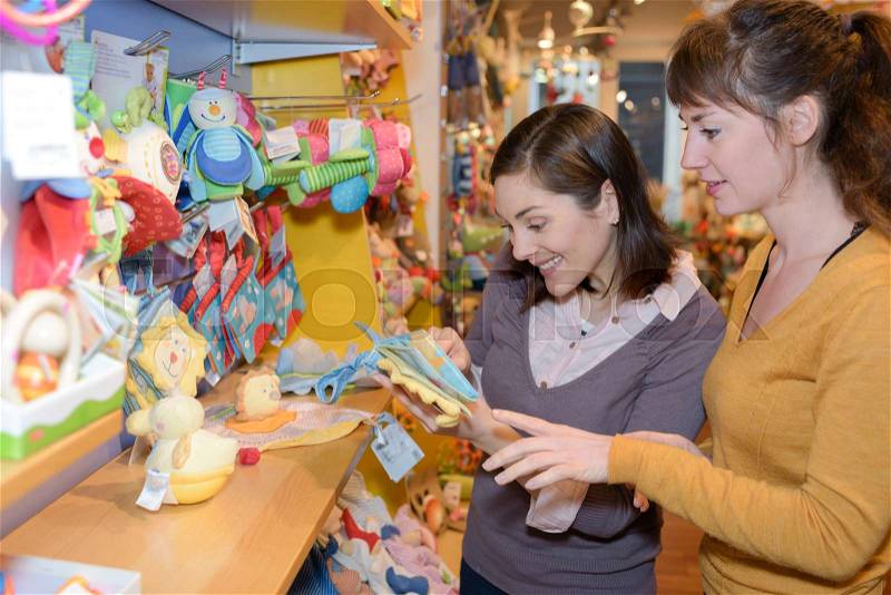 Attractive customer and seller at the toy store, stock photo