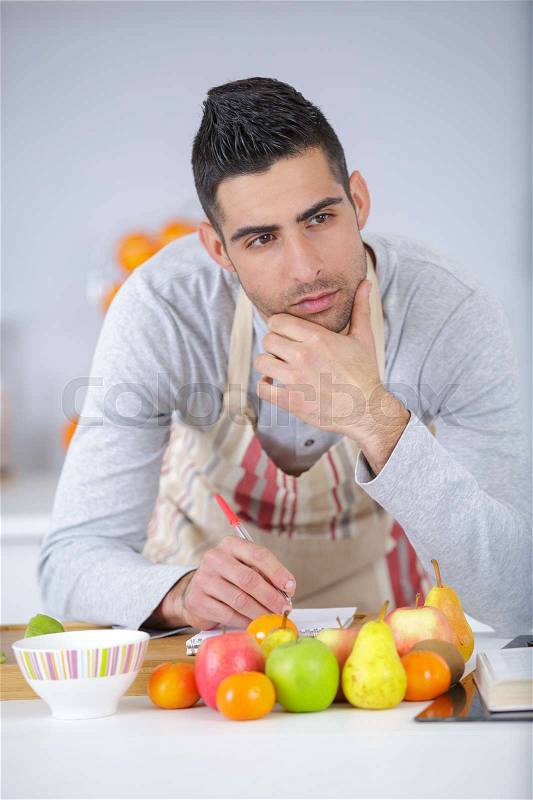 Man making food in house, stock photo
