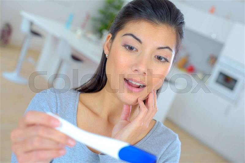 Woman with pregnancy test, stock photo