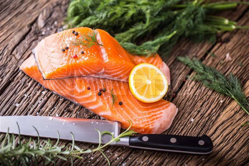 Salmon Fish..Raw salmon fillet pepper salt dill lemon rosemary on wooden table, stock photo