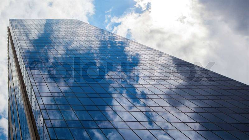 Blue modern office building with clouds reflection, stock photo