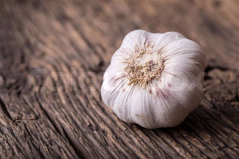 Garlic. Garlic Cloves and Garlic Bulb on vintage wooden table, stock photo