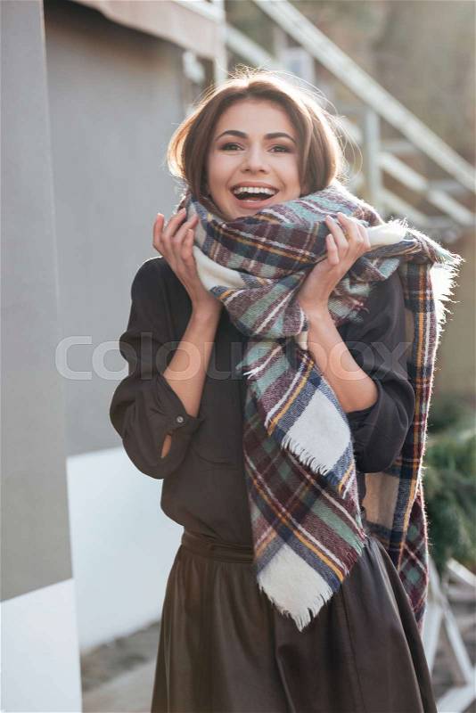 Photo of young gorgeous lady looking at camera while walking near cafe outdoors, stock photo