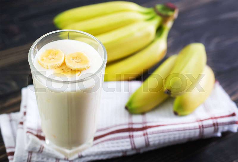 Banana yogurt in glass and on a table, stock photo