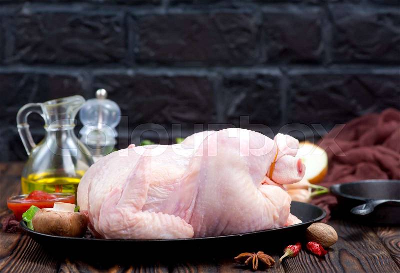 Raw chicken andaroma spice on a table, stock photo