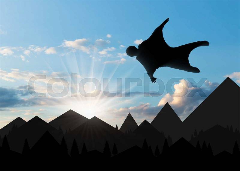 Wingsuit extreme sports. A man in a suit for wingsuit flying, mountains in background at sunset, stock photo