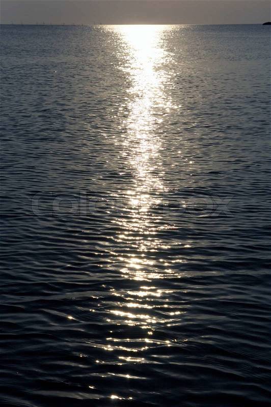Moonlight path on night sea water surface, stock photo