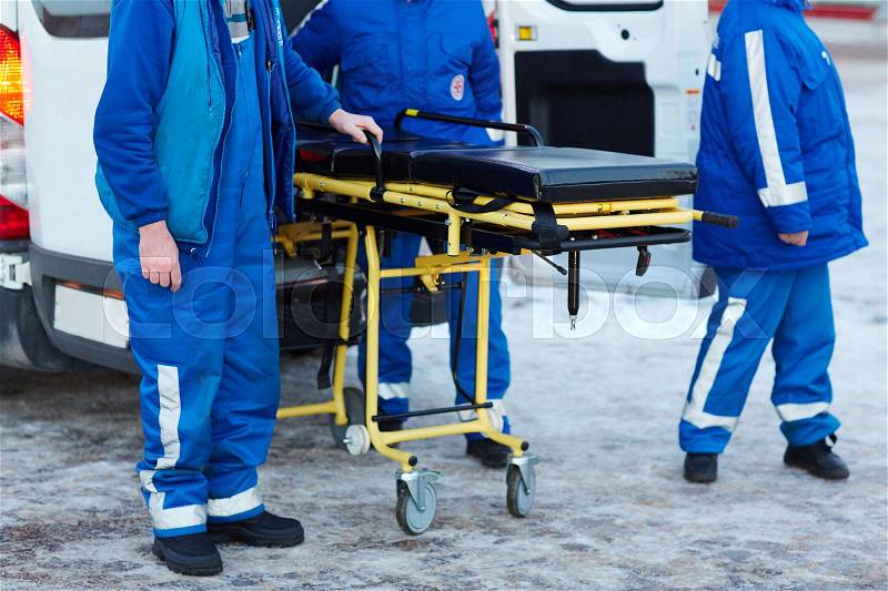 Emergency ambulance workers with stretcher, stock photo