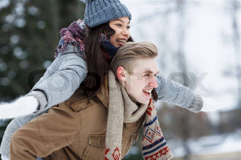 Side view of laughing dates in winterwear, stock photo