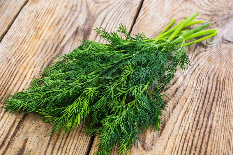 Fresh bunch of dill on the background of old board. Studio Photo, stock photo