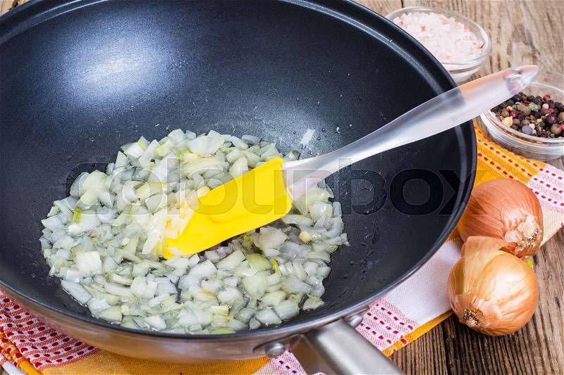 Fried onion in oil in a frying pan. Studio Photo, stock photo