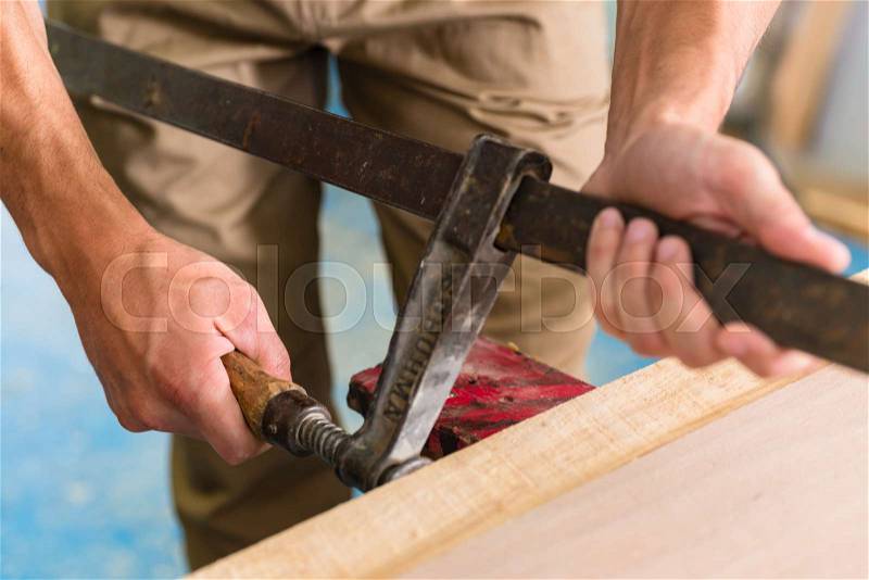 Cabinet maker working with screw clamp, stock photo